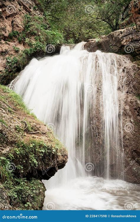 Beautiful Mountain Waterfall Captured With Motion Blur Stock Photo