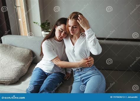 Two Young Women Cuddling In Living Room Stock Image Image Of Female