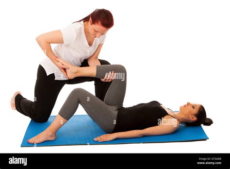 Physiotherapy Therapist Doing Leg Stretching Exercises With A Patient