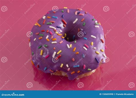 Purple Glazed Donut With Rainbow Sprinkles On Top Stock Photo Image