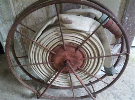 Antique cast iron wall decor fire engine. Fire Hose, Iron Stand, Fireman Decor, Vintage Fire Hose, Old Iron, Salvage, Reel, Vintage Fire ...