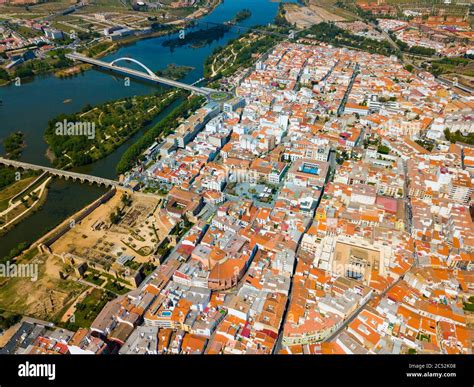 Scenic Aerial View Of Spanish City Of Merida With Ancient Roman Bridge