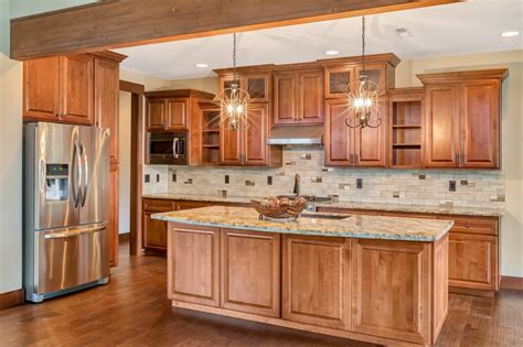 Traditional framed cabinetry construction is a staple of this design. Schuler Cabinets Cost - Homipet | Kitchen cabinet door ...
