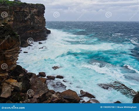 Pacific Ocean Storm Waves Crashing On Sandstone Cliff Australia Stock
