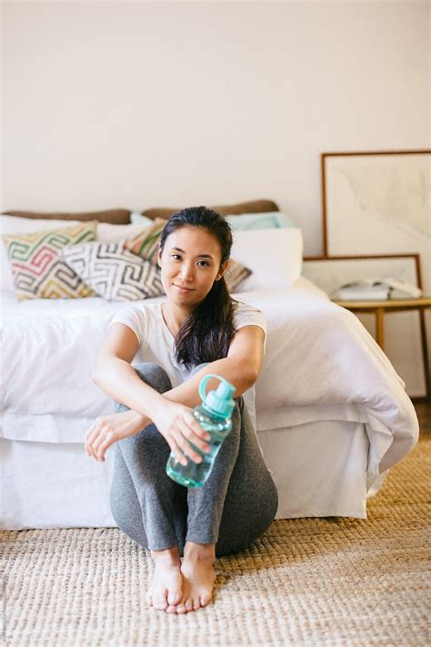 Young Asian Woman Resting After Doing Yoga At Home Del Colaborador