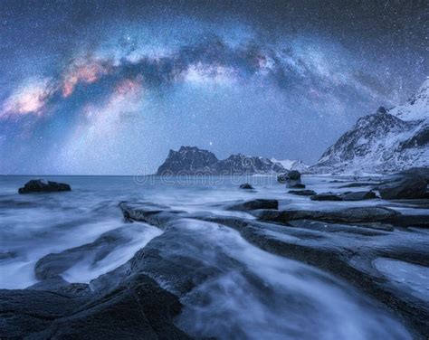 Milky Way Above Frozen Sea Coast And Snow Covered Mountains Stock Image