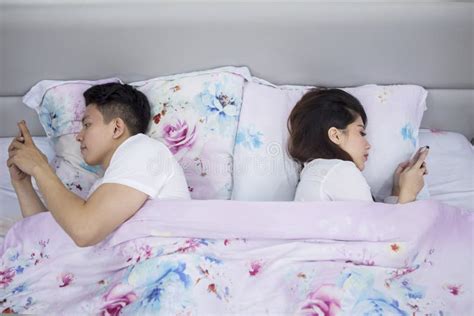 Couple Lying Back To Back Each Other On The Bed Stock Image Image Of