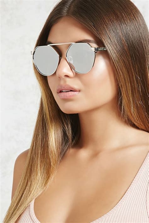 a pair of mirrored sunglasses featuring a bridgeless middle a high polish brow bar and a flat