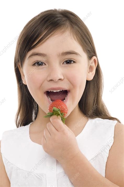 girl eating a strawberry stock image f002 7707 science photo library