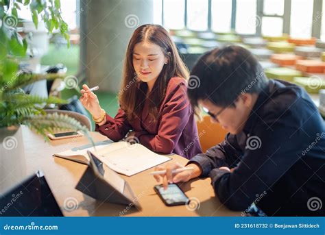 Asian Colleagues Discussing In Meeting Room Stock Photo Image Of