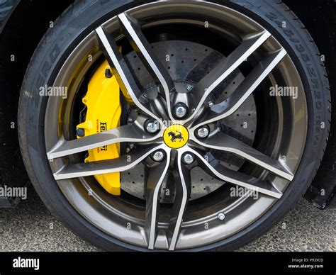 Black Ferrari Sports Car Detail Showing Five Spoked Alloy Wheel And