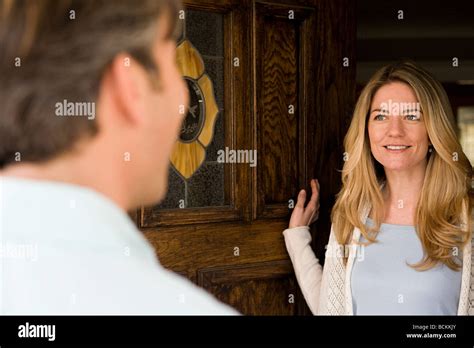 Woman Opening Door Stock Photo Alamy