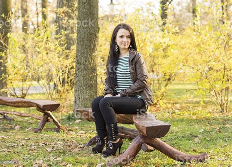 Girl Sitting On Bench Outdoors Stock Photo Download Image Now Adult