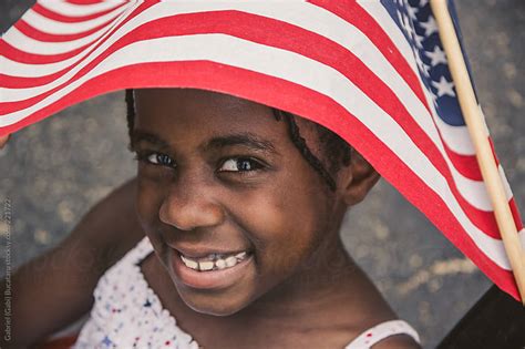 African American Girl With Usa Flag At A National Day Parade By Gabriel