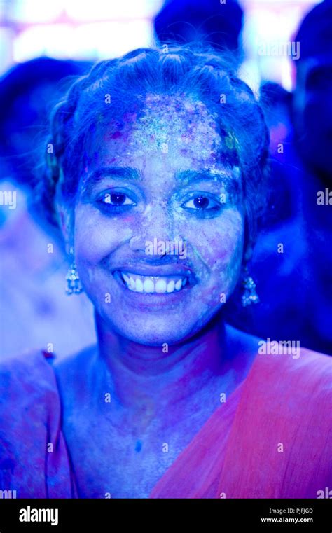Portrait Of An Indian Woman With Colors In Her Face At Holi Festival At