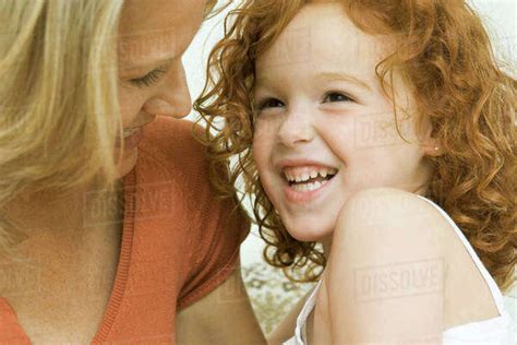 Mother And Daughter Laughing Together Close Up Stock Photo Dissolve