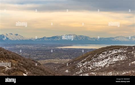 Panorama Lake And Vast Valley Viewed From A Mountain With Trees And