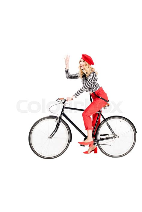 Happy Woman In Red Beret Waving Hand While Riding Bicycle Isolated On White Stock Image