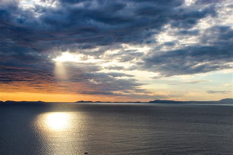 Free Stock Photo Of Sun Shining Through Clouds On Ocean