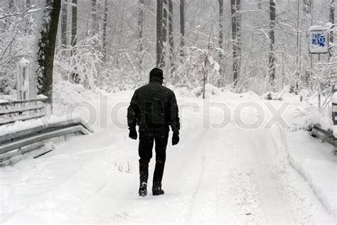 Man Walking In Snow Stock Photo Colourbox
