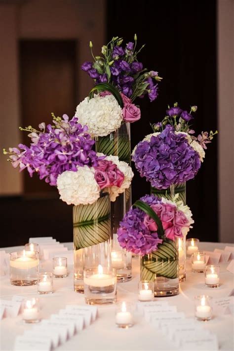Whether it's a mini mason jar centerpiece or a fruit and flower centerpiece, your table centerpieces will get your guests in the spring spirit. Purple Wedding Ideas with Sophistication - MODwedding
