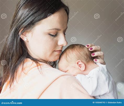 Pretty Woman Holding A Newborn Baby In Her Arms Stock Photo Image Of