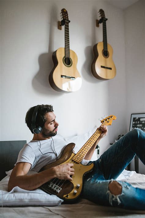 Man Playing Bass Guitar At Home By Simone Wave