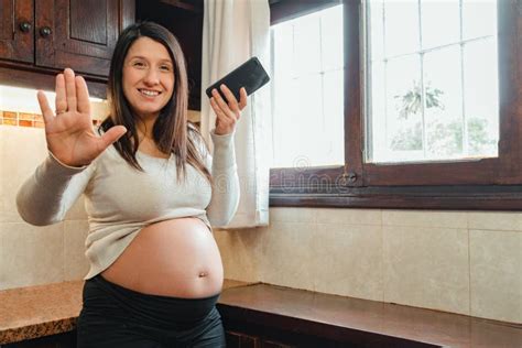 Pregnant Latina Woman Asking The Camera To Stop While Recording A Voice Message Stock Image