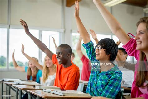 Students Raising Their Hands To Answer Questions High Res Stock Photo