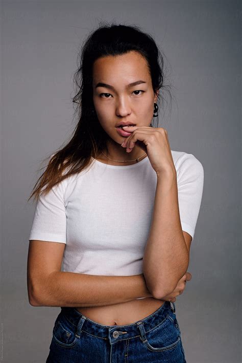 Beautiful Asian Girl With Finger On Lip Del Colaborador De Stocksy Danil Nevsky Stocksy