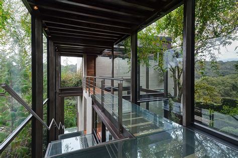 Outdoor Elevated Glass Walkway Connects Two Sections Of House Modern