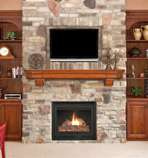 Cultured rock runs top to bottom, accenting the height of the vaulted ceiling. stack stone fireplaces between the shelves