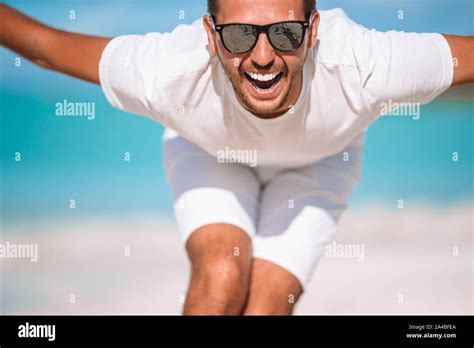 Young Man On The Beach Look And Smile To Camera Stock Photo Alamy