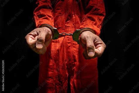 Handcuffs On Accused Criminal In Orange Jail Jumpsuit Law Offender Sentenced To Serve Jail Time