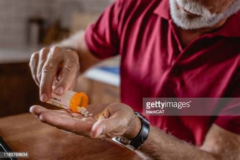 man popping pills photos and premium high res pictures getty images