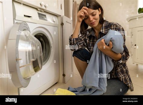 Girl Puts Clothes In Washing Mashine Stock Photo Alamy