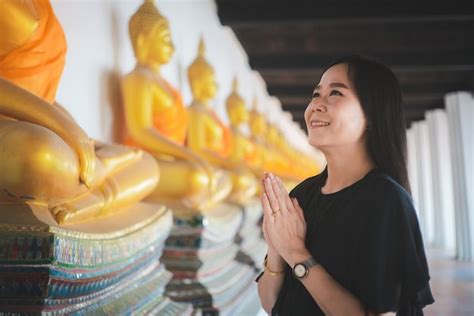 Premium Photo Asian Woman Pays Homage To The Buddha Statue With Respect And Faith