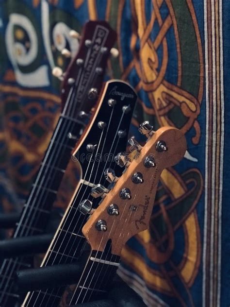 Close Up Of Three Guitar Head Stocks Guitars In Studio On Stands