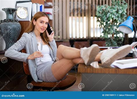 Female Secretary Doing Paperwork In Office Talking On Phone Stock Image