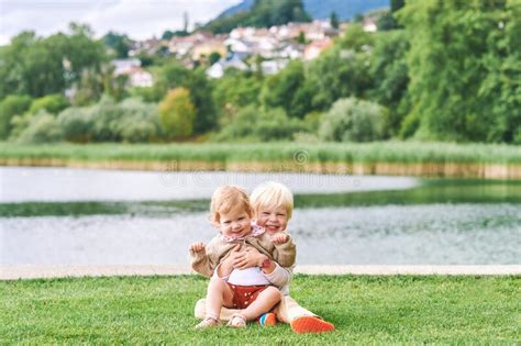 Outdoor Portrait Of Adorable Happy Children Playing Together Next To