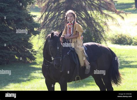 A Young Native American Indian Lakota Sioux Boy Riding A Black Horse