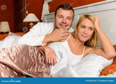 Smiling Husband And Wife Striking A Romantic Pose Stock Photo