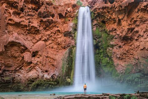 Man Standing Below Mooney Falls Supai Arizona Usa