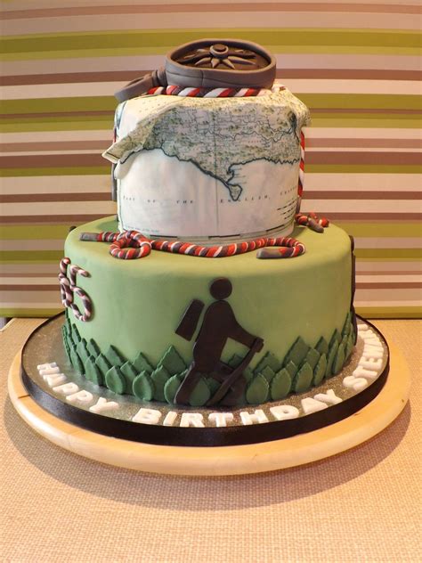 There Is A Green Cake With A Map On It And A Person Holding A Cane