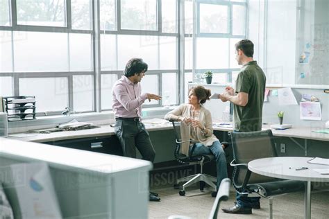 Three Coworkers Talking In An Office Stock Photo Dissolve