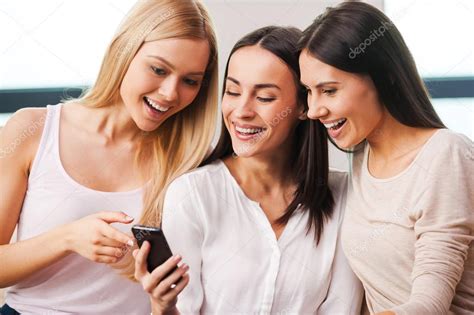 Women Looking At Mobile Phone Stock Photo By Gstockstudio