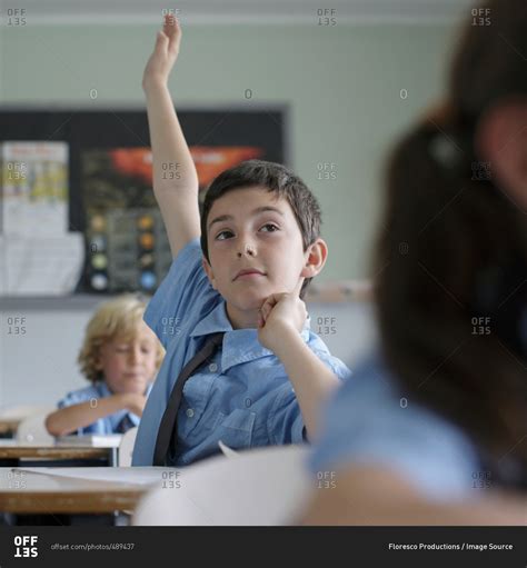 School Boy Raising Hand In Class Stock Photo Offset