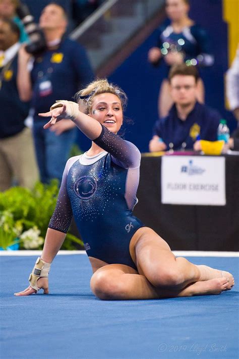 A Woman Is Doing Gymnastics On The Floor