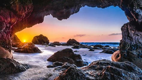 Epic Sunset From A Sea Cave Wallpaper Backiee