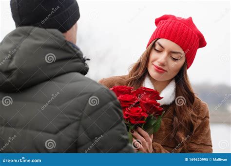 A Man Gives Roses To A Beautiful Woman Stock Image Image Of T